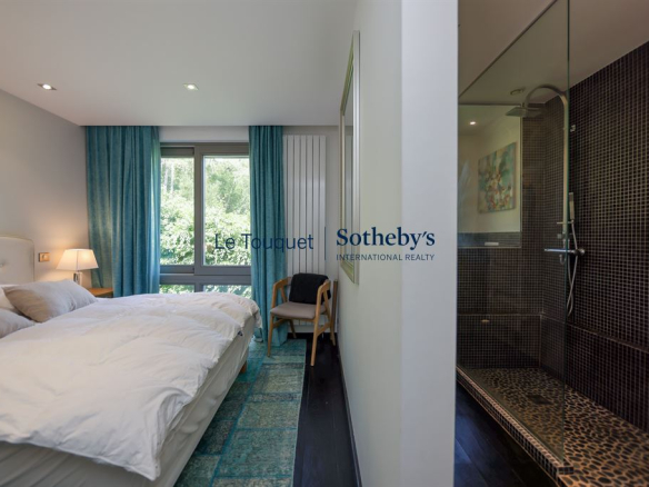 Bedroom in a contemporary villa with en-suite bathroom, overlooking the forest.
