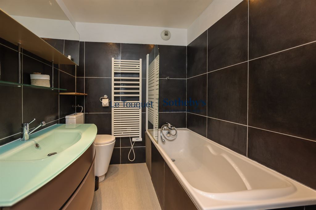 Bathroom of an apartment in Le Touquet Modern bathroom with bathtub and sink in an apartment in Le Touquet