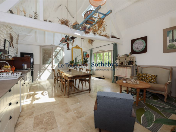 Interior of a renovated property with a bright dining room and living room.