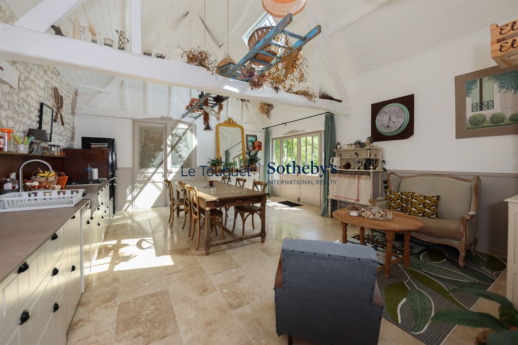 Interior of a renovated property with a bright dining room and living room.