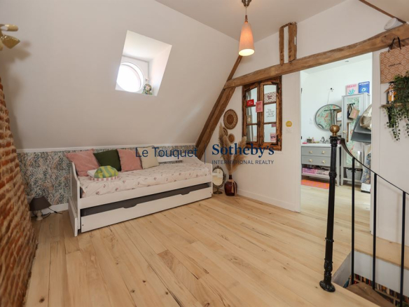 Interior of a renovated cottage with brick walls and a bright living space.
