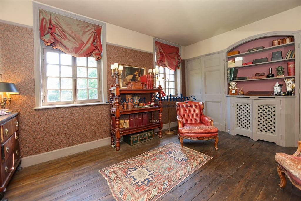 Interior of a historic property with an elegant living room and antique furniture.