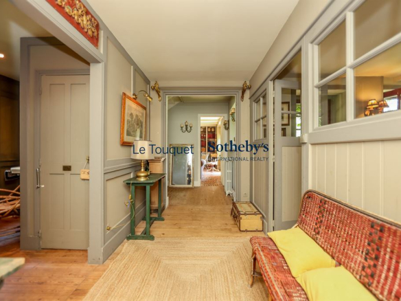 Interior of a historic property in Le Touquet-Paris-Plage with a hallway and a living room.