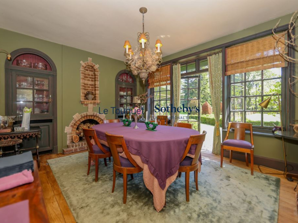 Dining room of a historic property with round table and elegant decor.