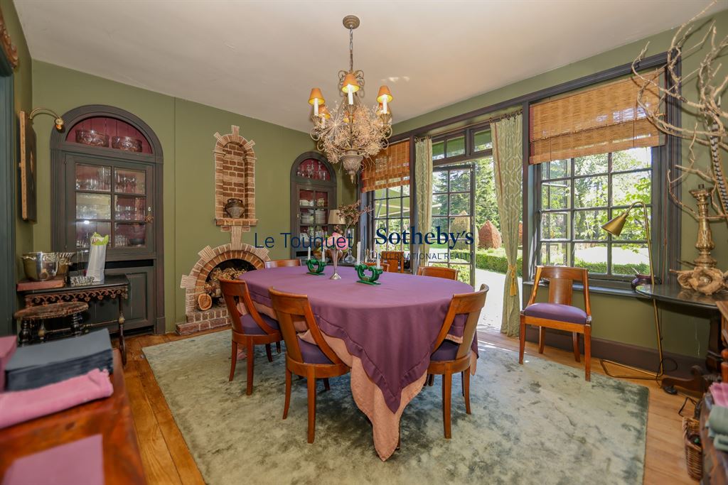 Dining room of a historic property with round table and elegant decor.