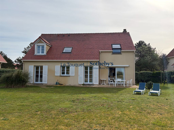 Villa avec jardin et chaises longues, située à Le Touquet-Paris-Plage, face aux dunes.