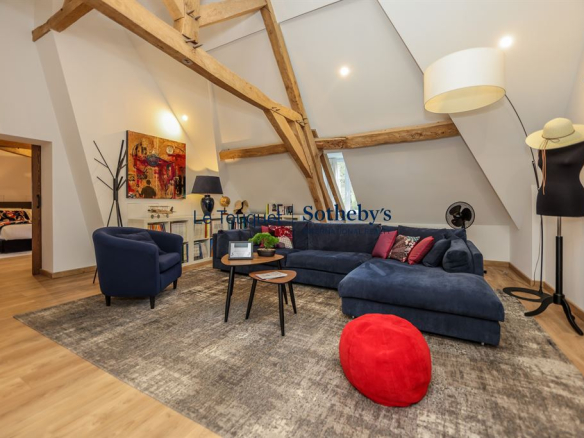 Interior of an 18th-century manor house with a modern living room and exposed beams.