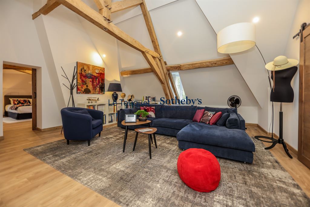 Interior of an 18th-century manor house with a modern living room and exposed beams.
