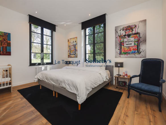 Bright room with double bed and modern decor in an 18th century manor house.