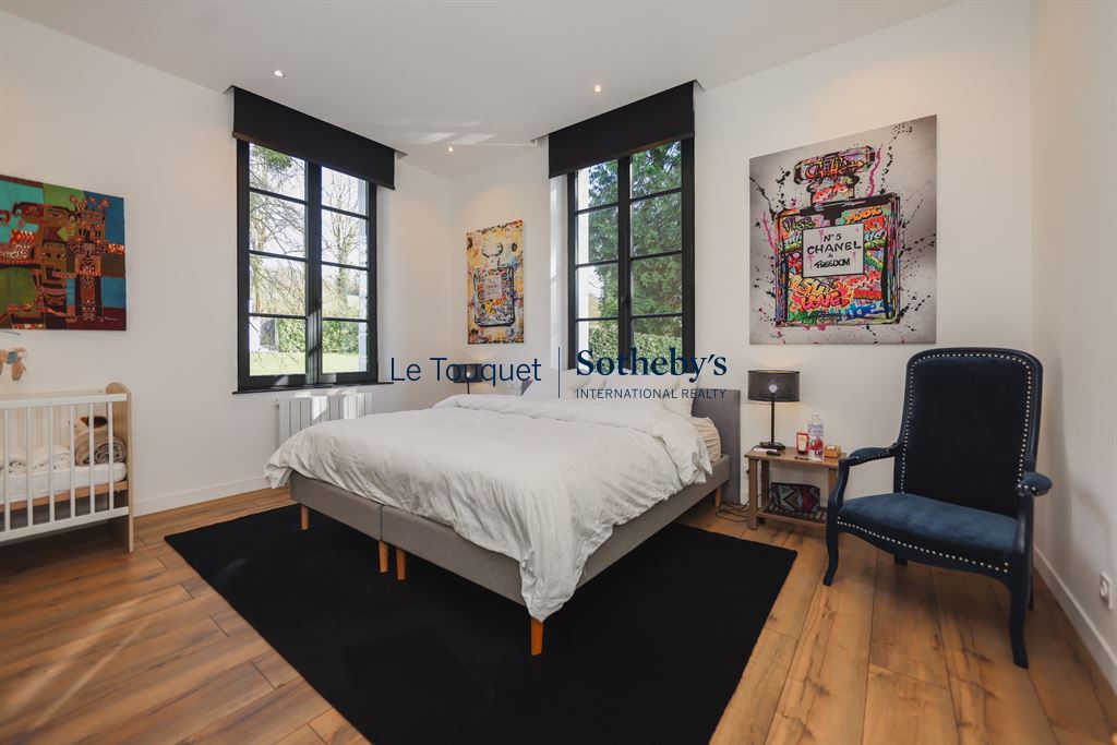 Bright room with double bed and modern decor in an 18th century manor house.