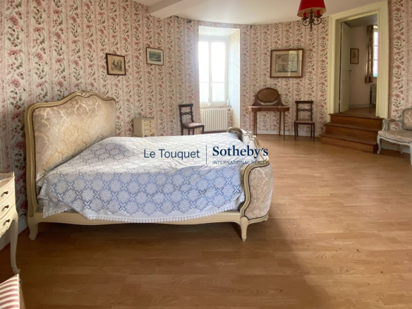 Chambre d'un château du XVIIIème siècle avec un décor floral et un mobilier ancien.