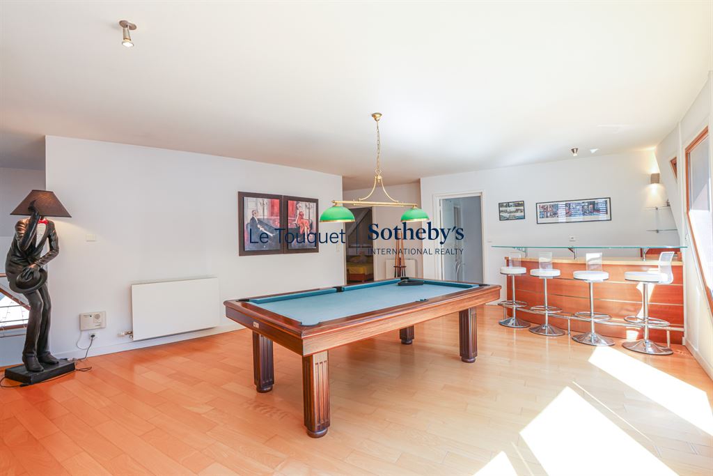 Interior of a contemporary villa with a pool table and bar, Le Touquet-Paris-Plage.