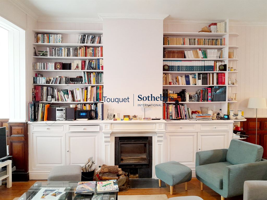 Interior of a villa with library, fireplace and modern furniture in Le Touquet-Paris-Plage.